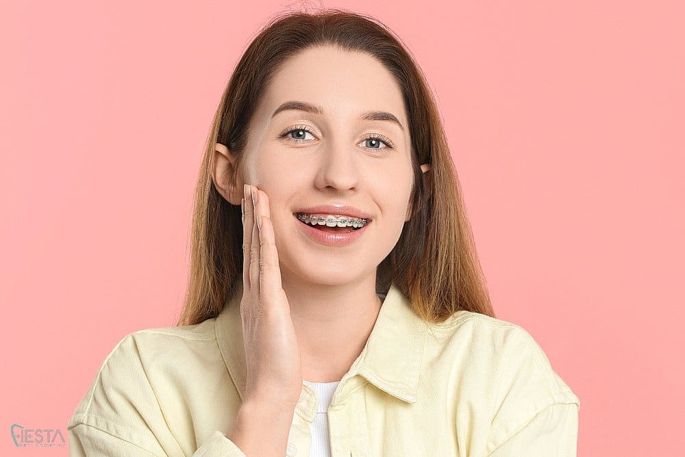 smiling woman metal braces after understanding about how long do braces take in Sam Antonio, TX