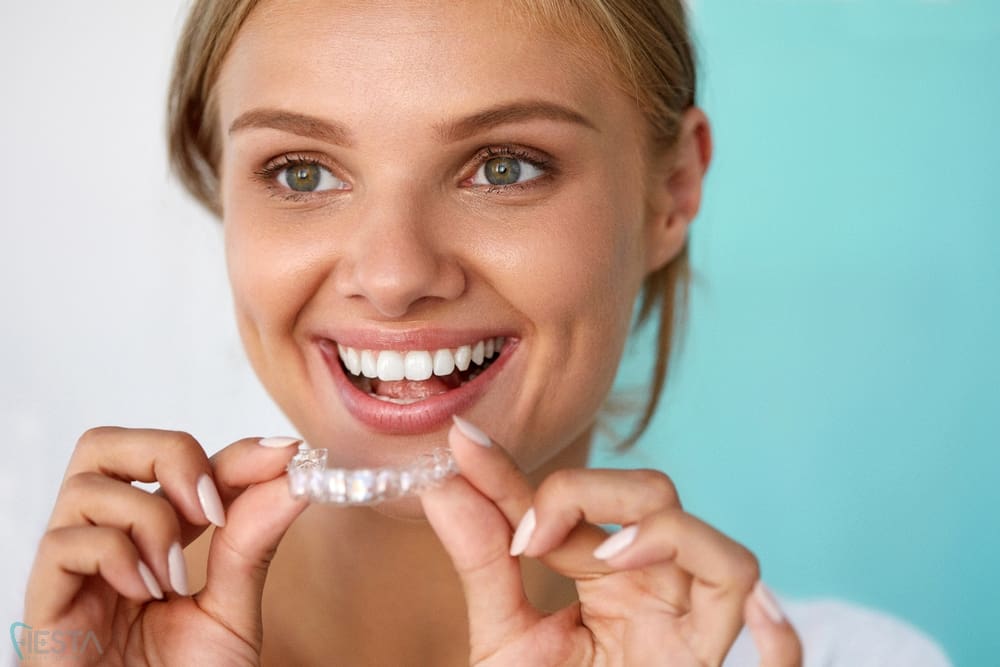 smiling woman with beauiful smile using invisalign clear aligners - How Does Invisalign Work in San Antonio, TX
