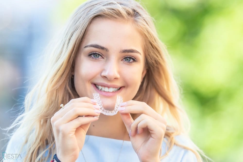 invisalign clear aligners orthodontics concept young attractive woman - How Long Does Invisalign Take in San Antonio, TX